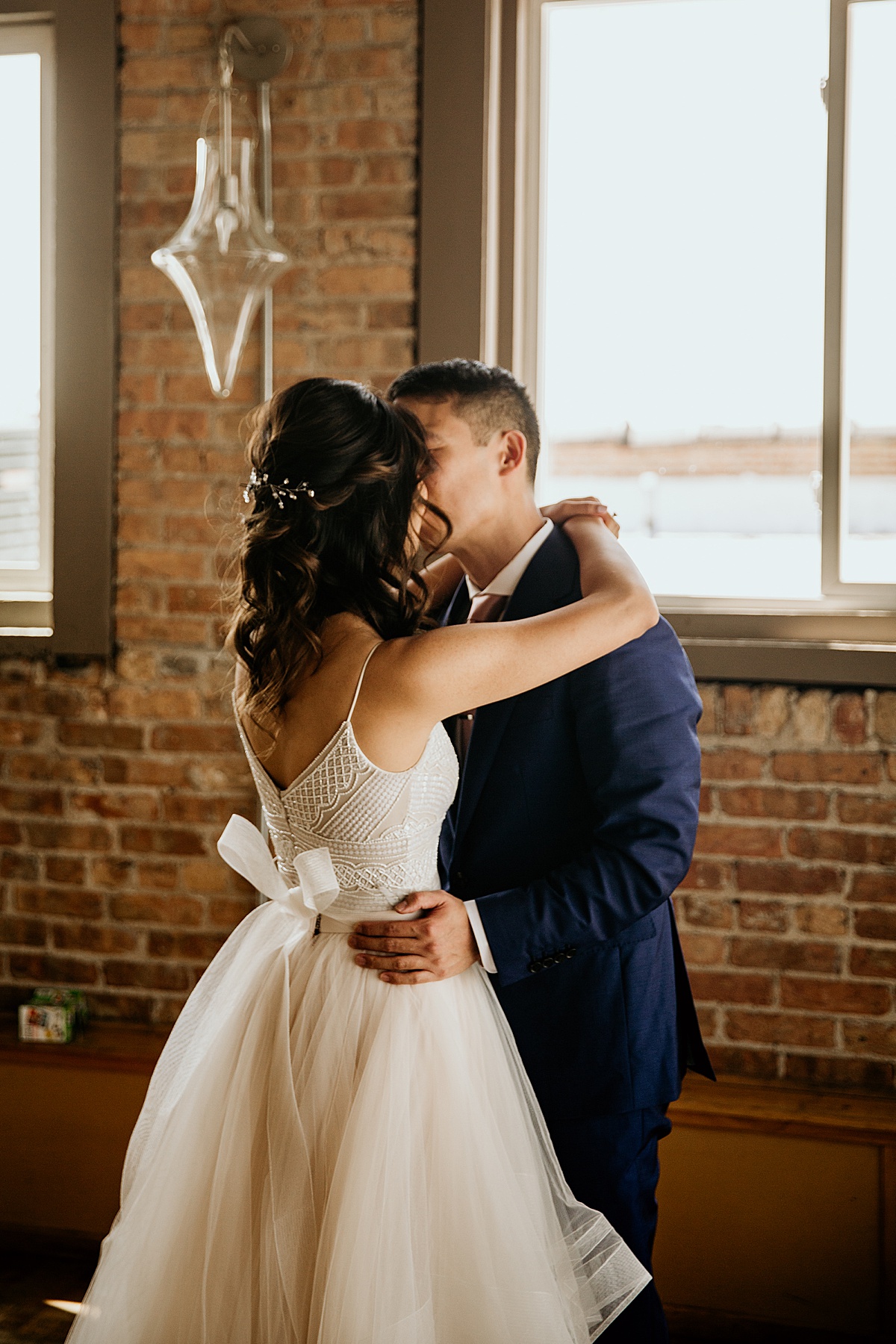 bride and groom kissing after their first look