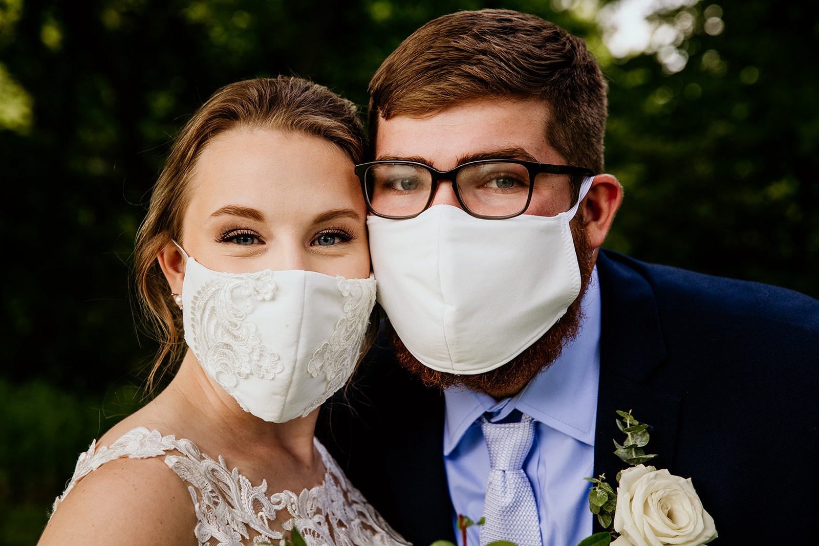 Couple cuddling up with masks on for a covid social distancing ceremony