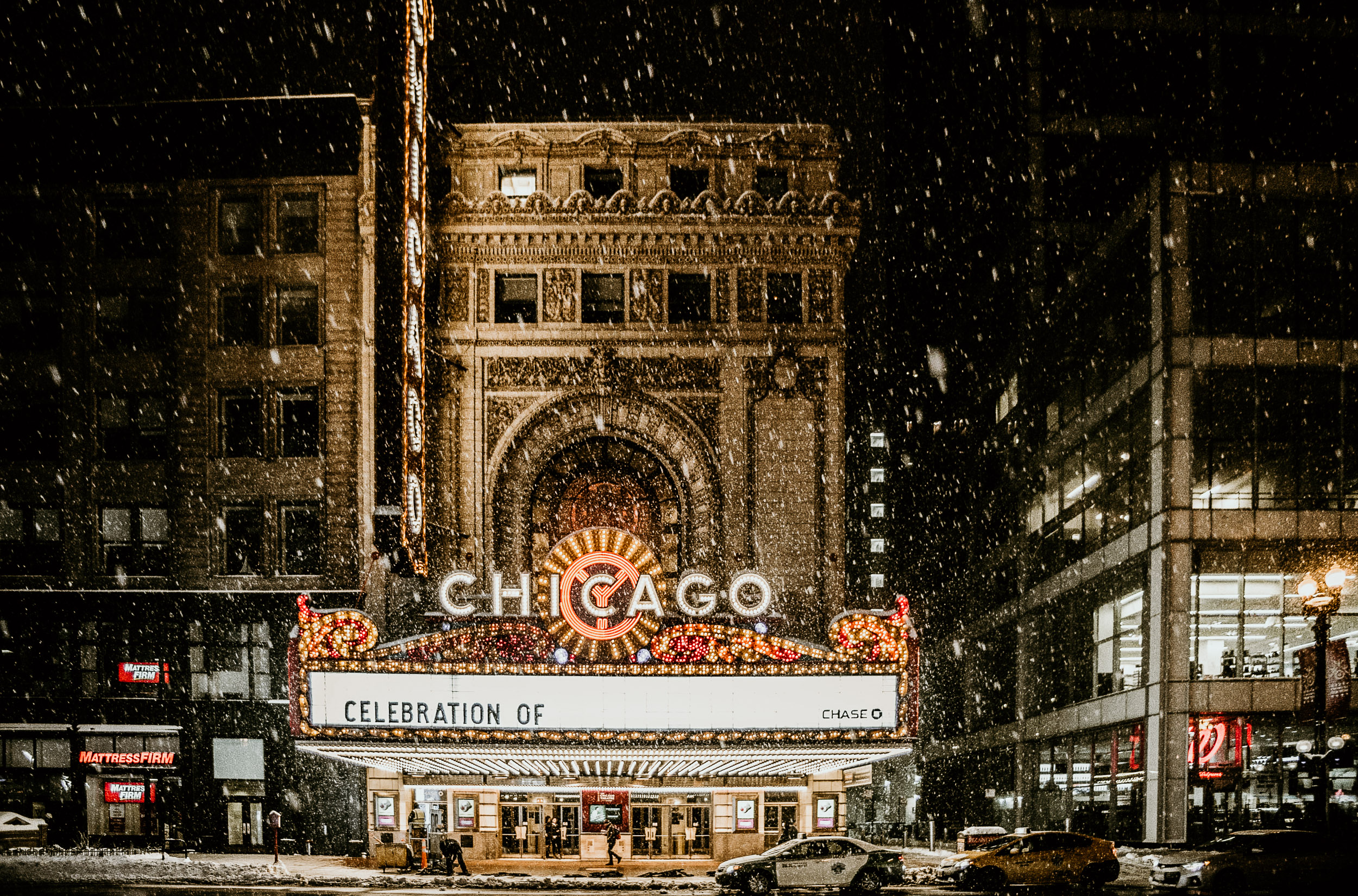 chicago theater at night with snow falling down