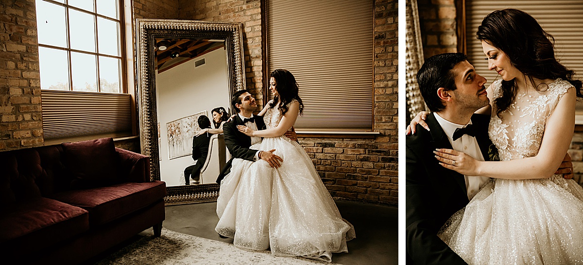 Bride sitting on grooms lap looking at each other in an elegant bridal room.