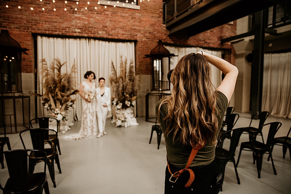 Photographer photographing a lesbian wedding couple.