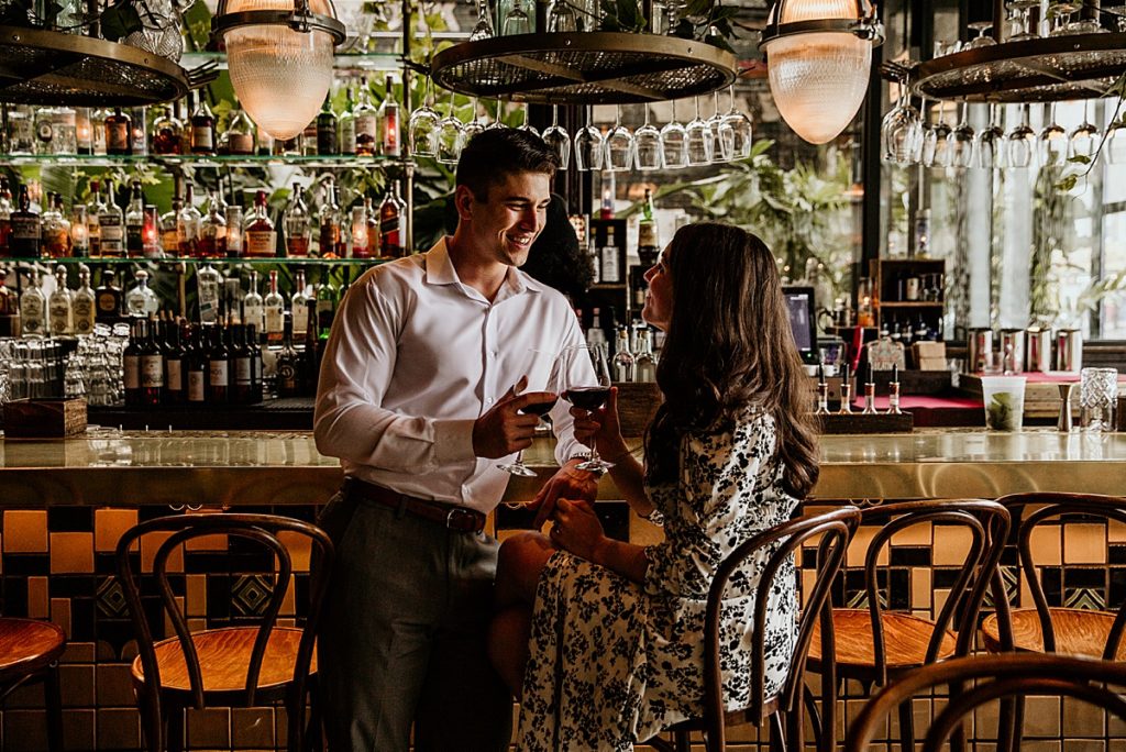 Man and woman flirting at a bar restaurant.