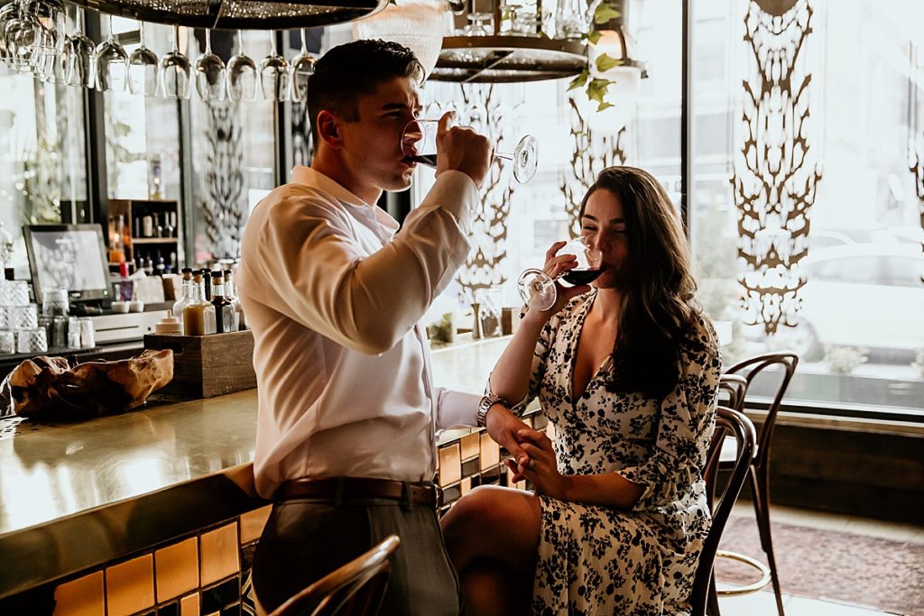 Man and woman drinking wine at a bar restaurant.