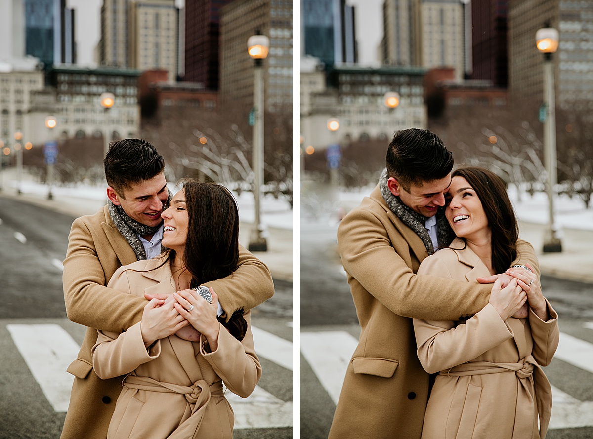 Man hugging his girlfriend from behind while they smile at each other. 