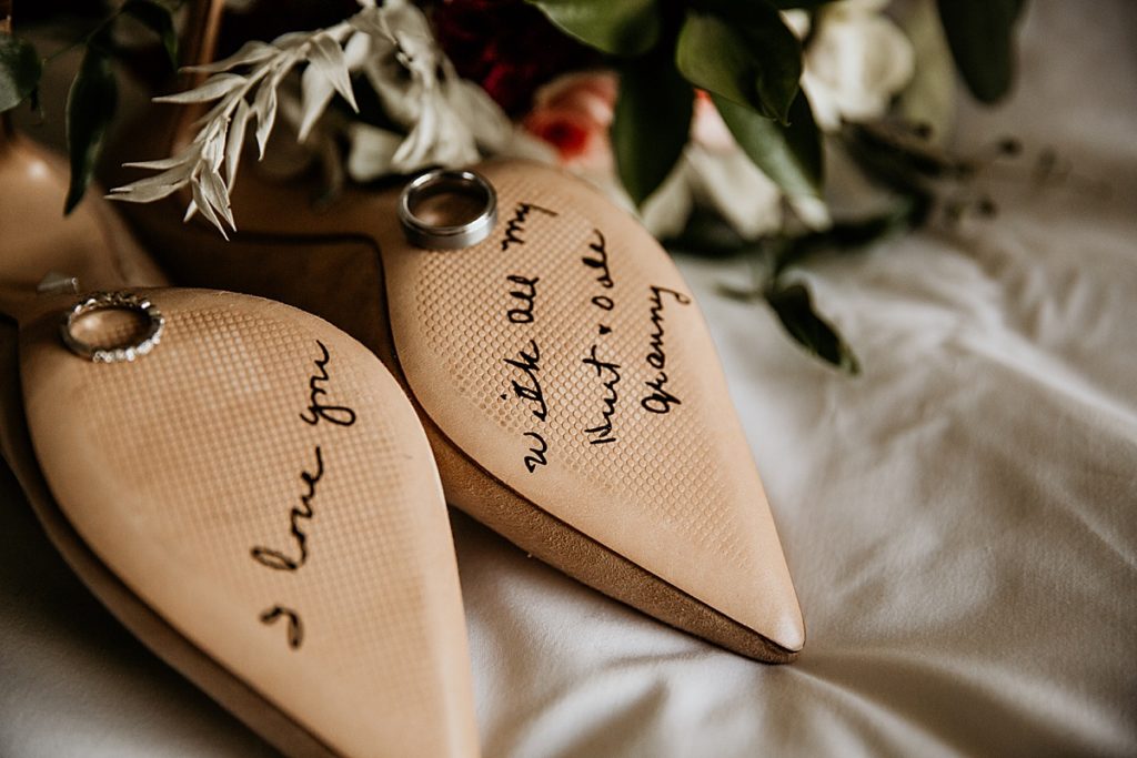 Brides wedding shoes with writing on the bottom