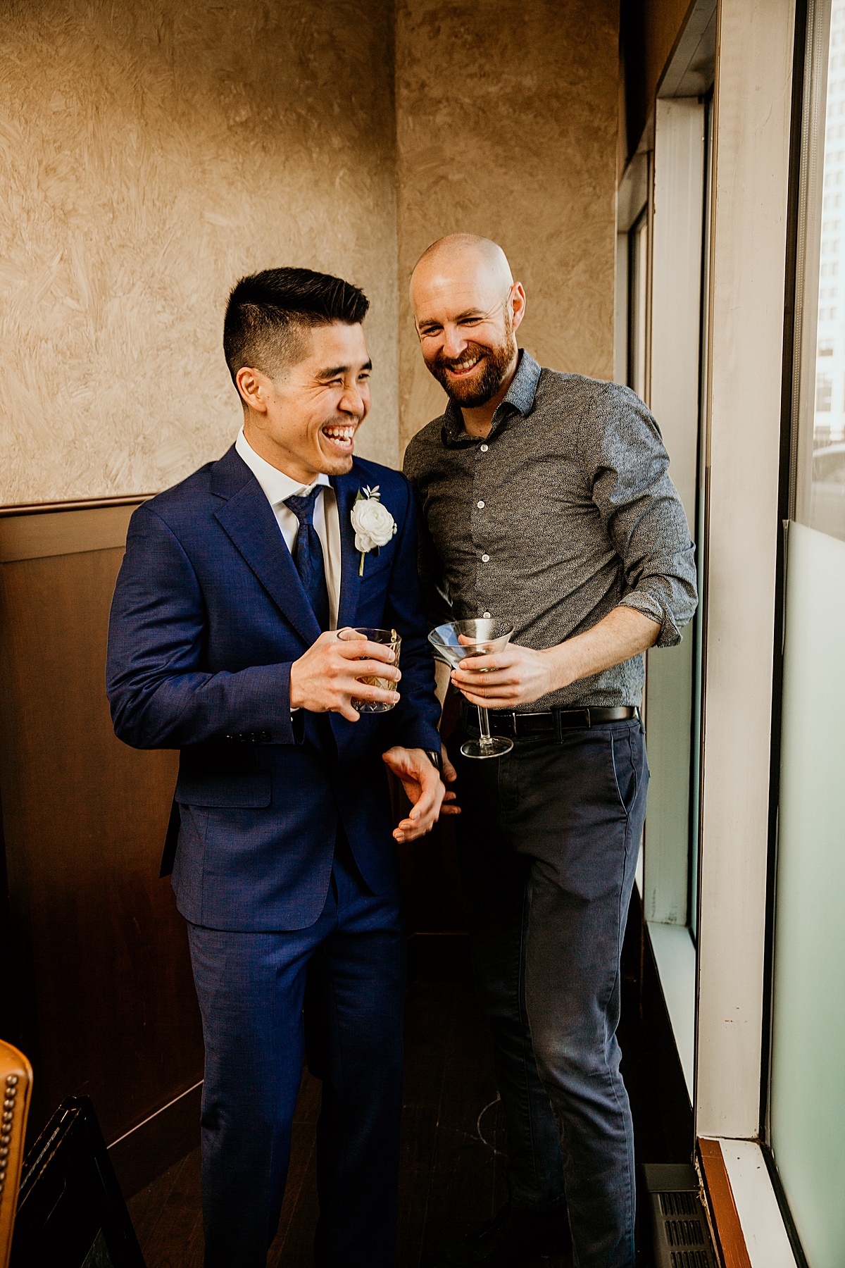 Groom and best man laughing 