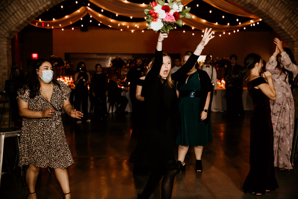 girl catching the bouquet at a wedding