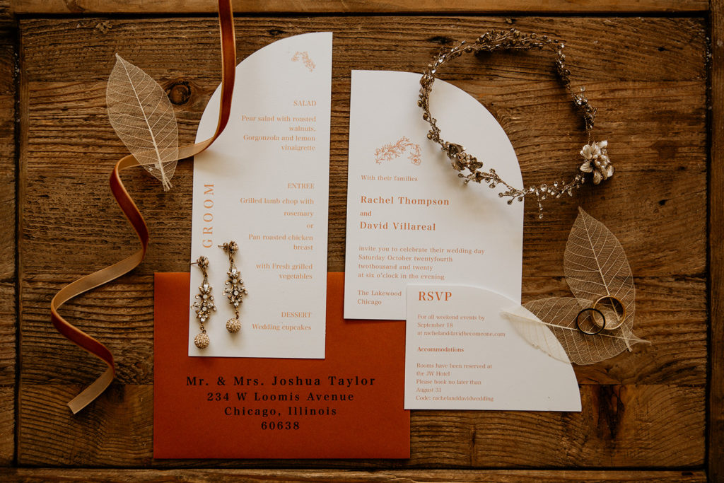 boho wedding detail lay flat with jewelry and invitations