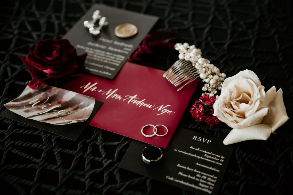 moody wedding detail lay flat with jewelry and invitations