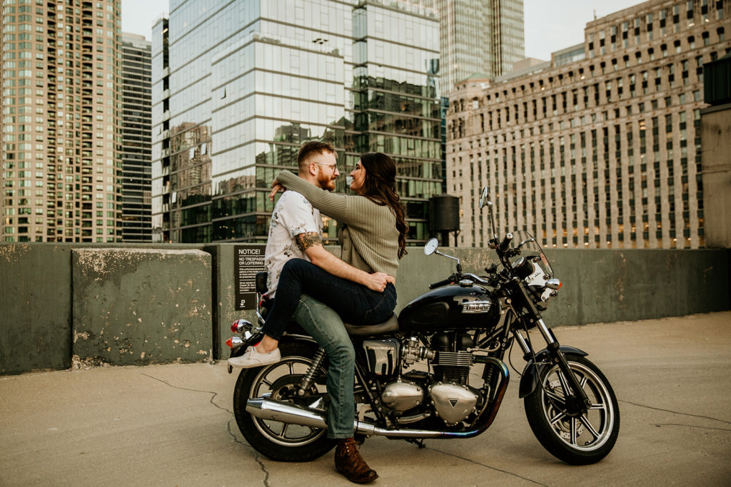 Couple's engagement photos with a motorcycle on a city parking garage rooftop of chicago