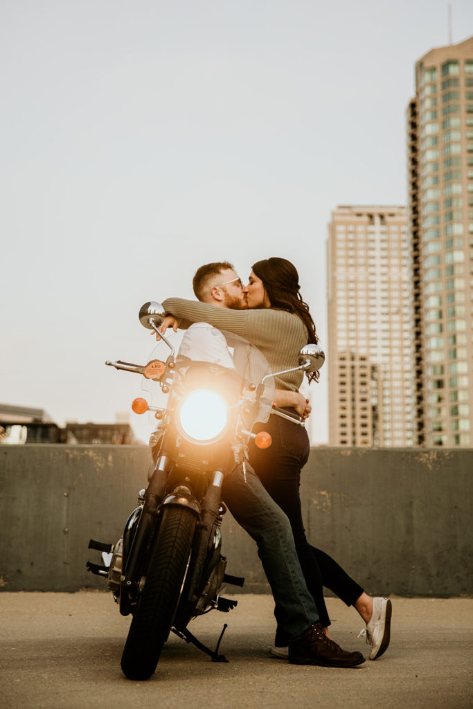 Couple's engagement photos with a motorcycle on a city parking garage rooftop of chicago