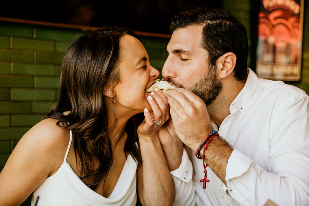 Couple's engagement photos at Cruz Blanca restaurant of chicago eating a taco