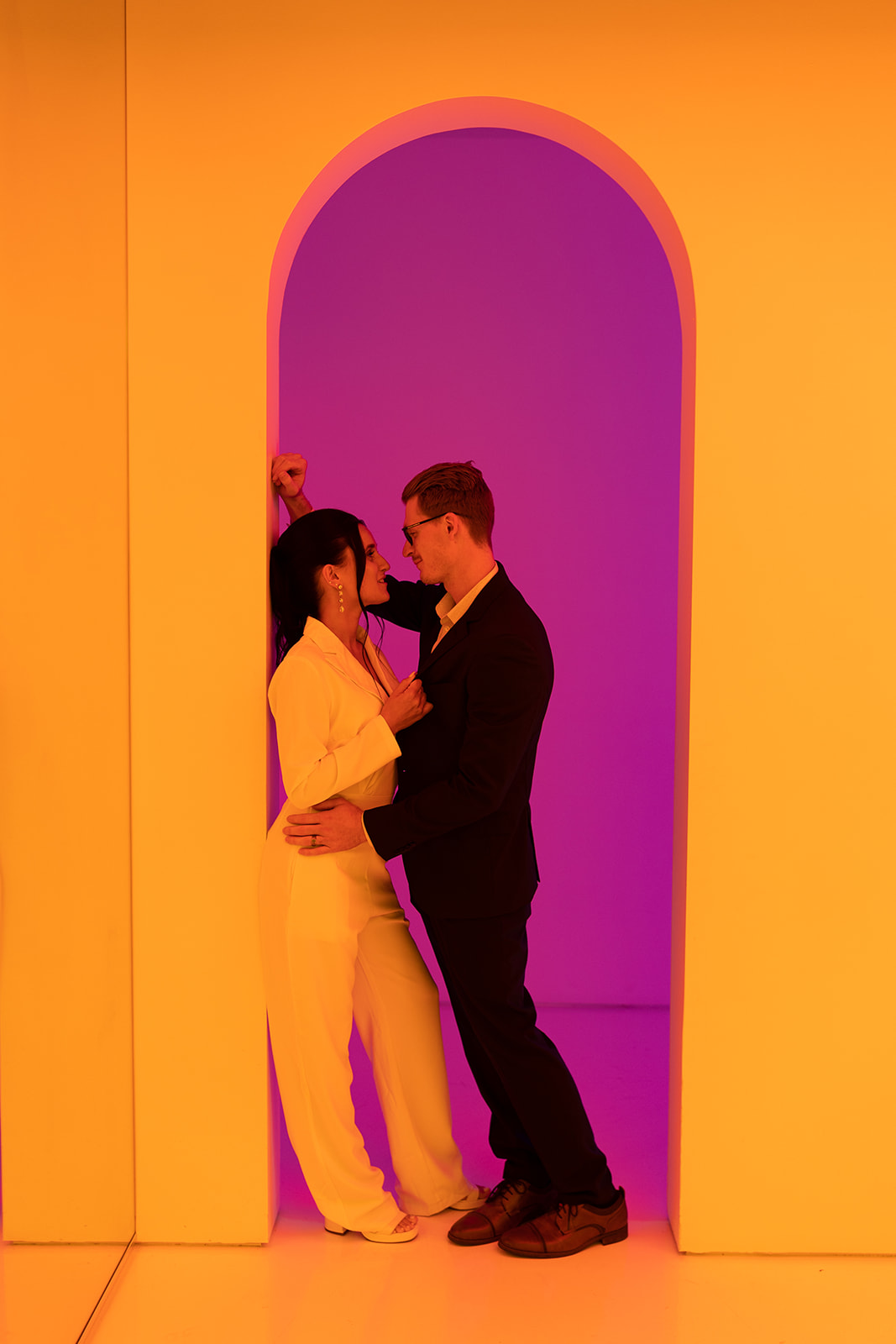 Couple in colorful archway at color factory museum chicago