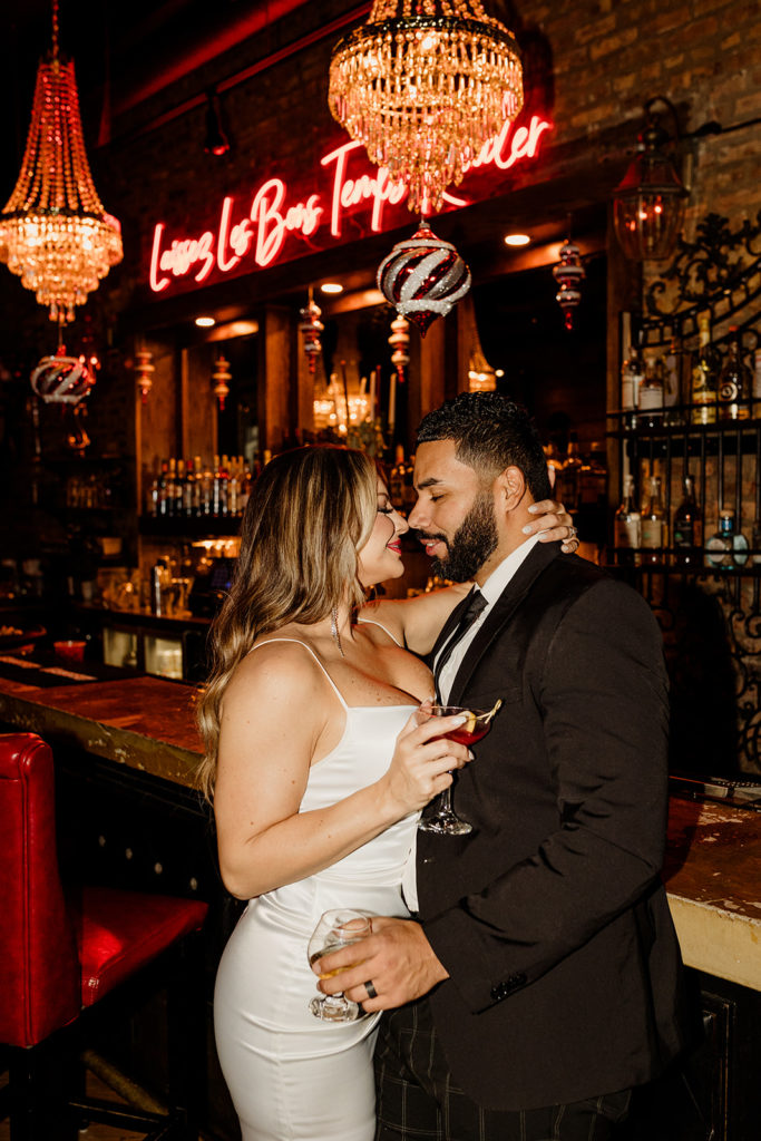 engaged couple having drinks at chicago bar at night