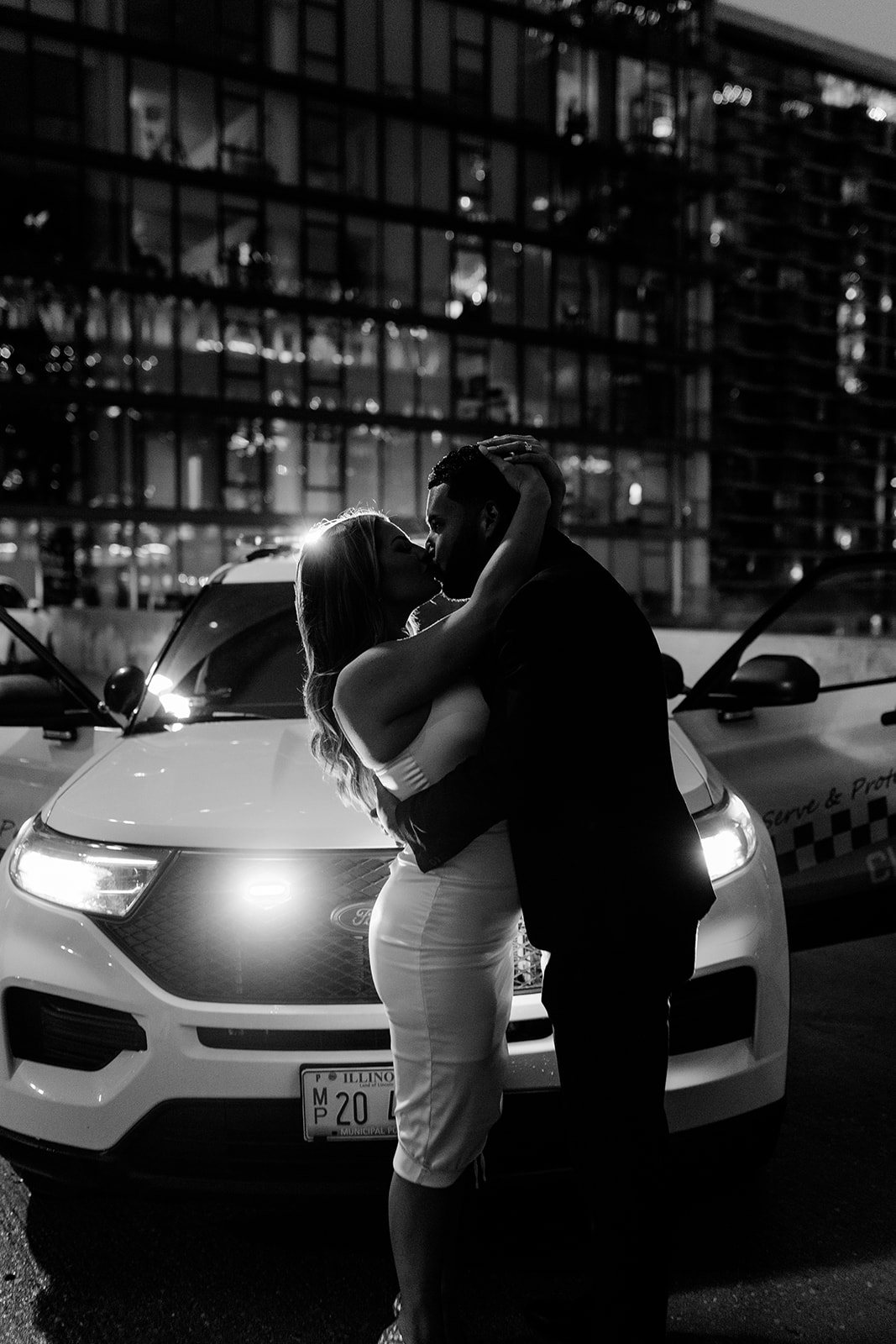 engaged couple in downtown chicago at night with car headlights