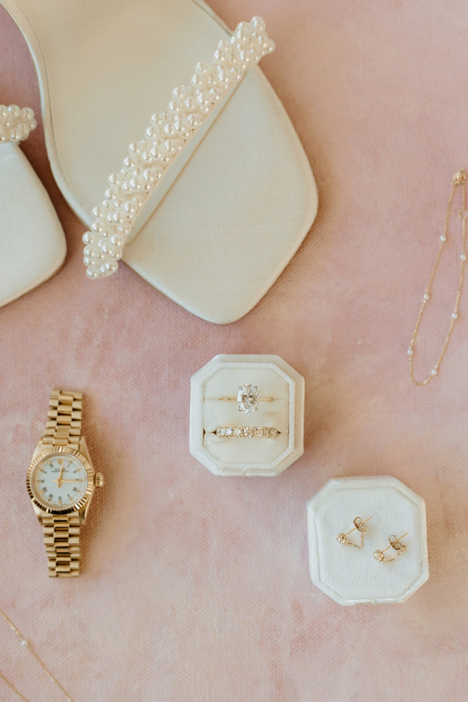 flat lay details of wedding shoes and jewelry 