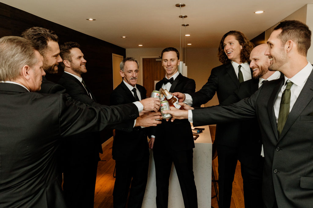 groom and groomsmen with drinks before wedding day