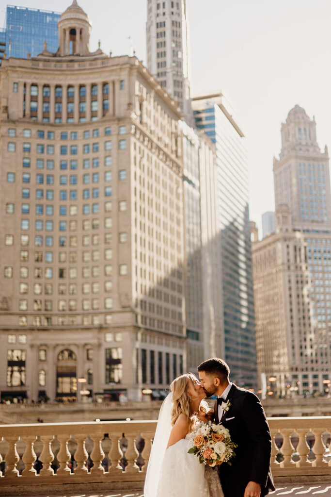 bride and groom kissing in downtown chicago on morning of wedding day
