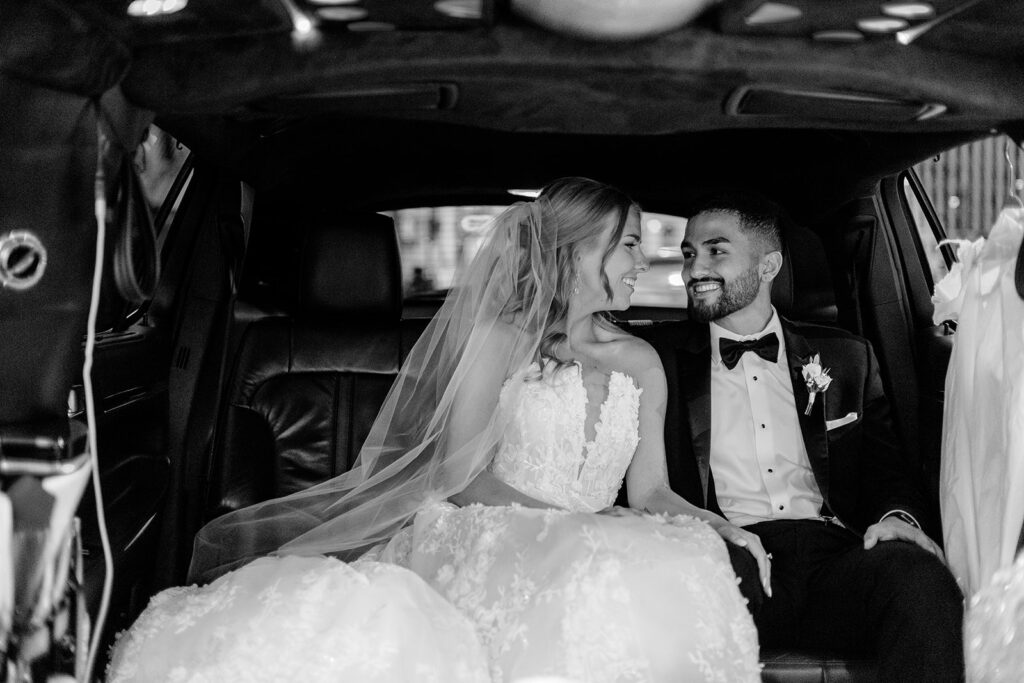 bride and groom in car on morning of wedding day